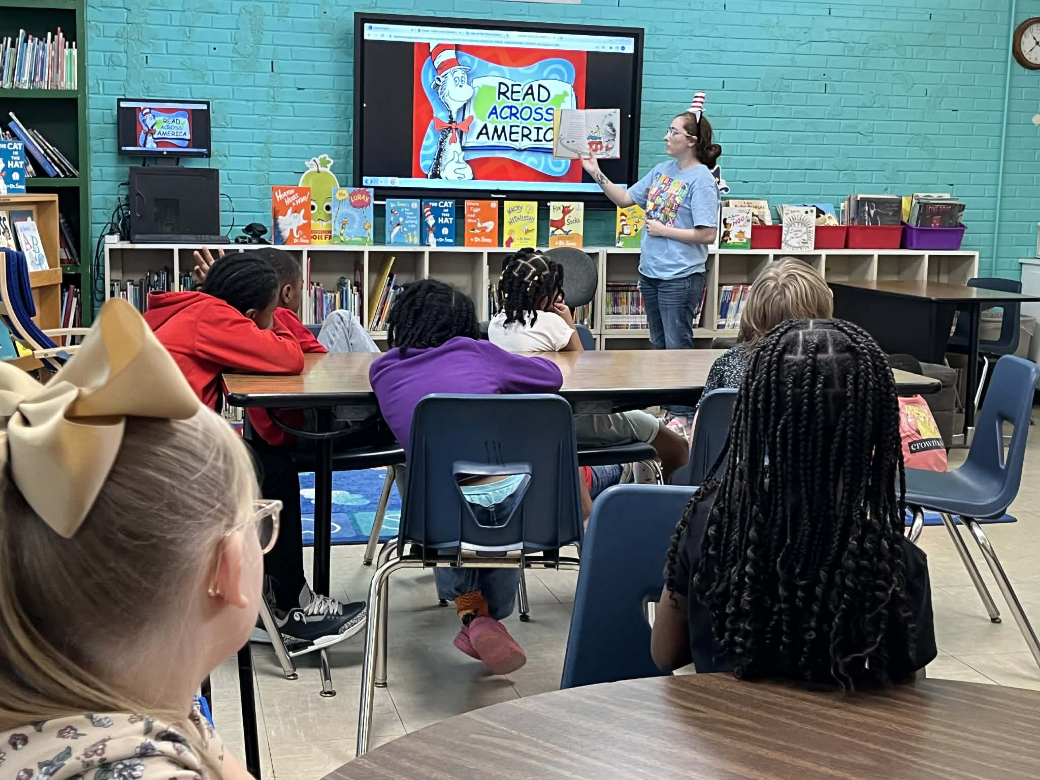 Someone reading a book to a class of children