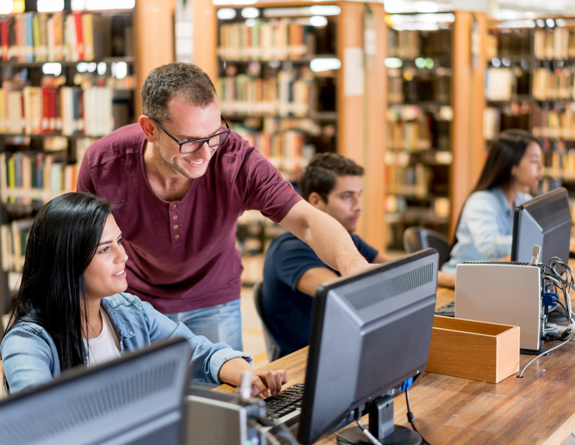 Library staff assisting a patron with printing